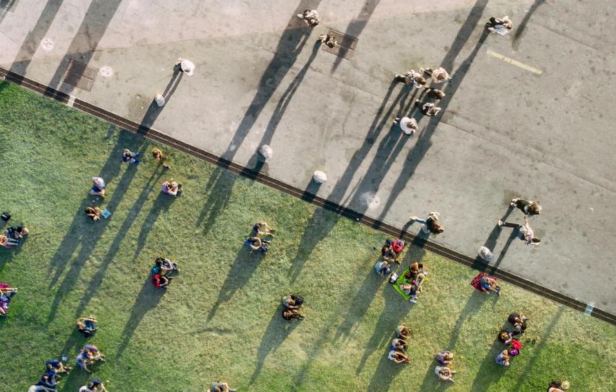 Aerial view of people on grass and pavement